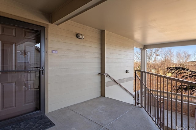 view of exterior entry with a balcony