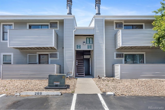 10150 E Virginia Ave Unit 11-202, Denver, CO 80247 - view of property with uncovered parking and stairs