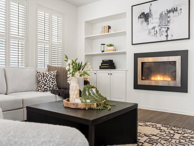 living room with hardwood / wood-style flooring and built in features