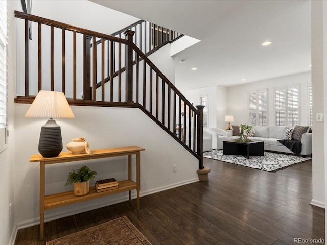 staircase with hardwood / wood-style flooring