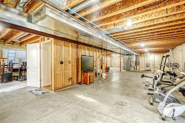 unfinished basement featuring heating unit