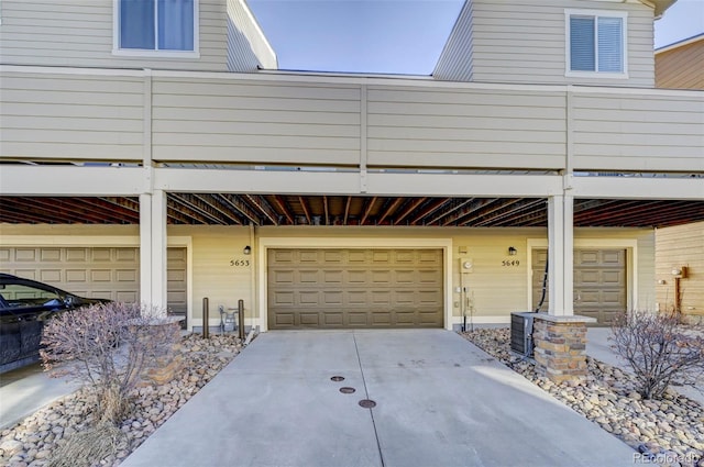 view of side of home with a garage and a balcony