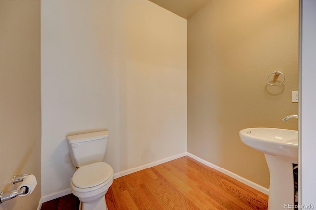 bathroom featuring hardwood / wood-style floors and toilet