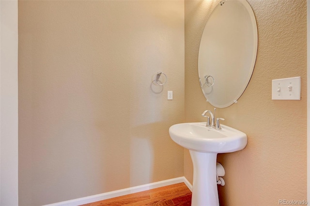 bathroom with hardwood / wood-style flooring and sink