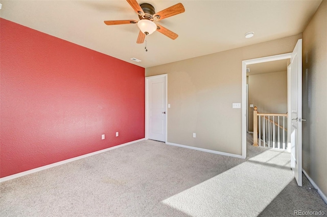 unfurnished bedroom with light colored carpet and ceiling fan