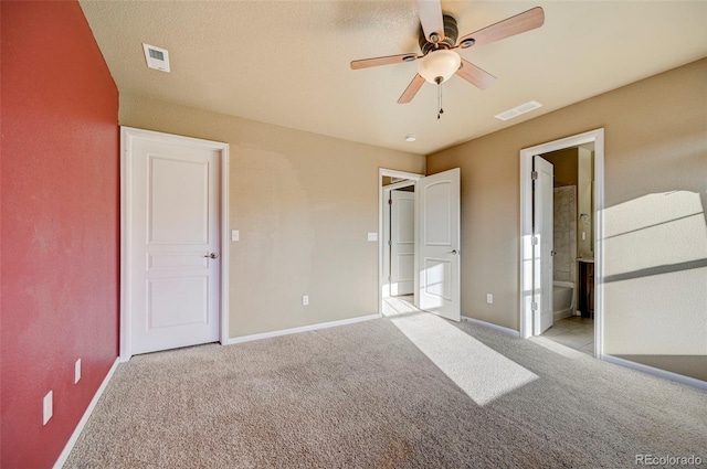 unfurnished bedroom with ceiling fan, ensuite bath, and light colored carpet