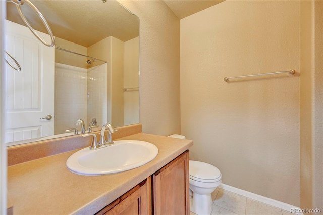 bathroom featuring tile patterned flooring, vanity, walk in shower, and toilet