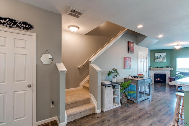 stairway with hardwood / wood-style flooring