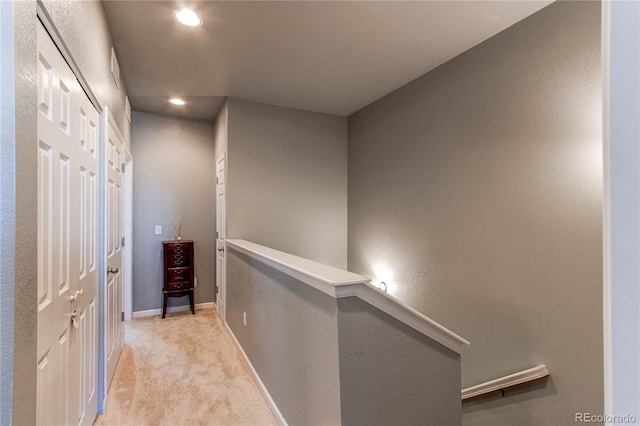 hallway with light colored carpet