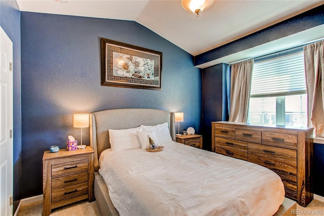 carpeted bedroom featuring lofted ceiling