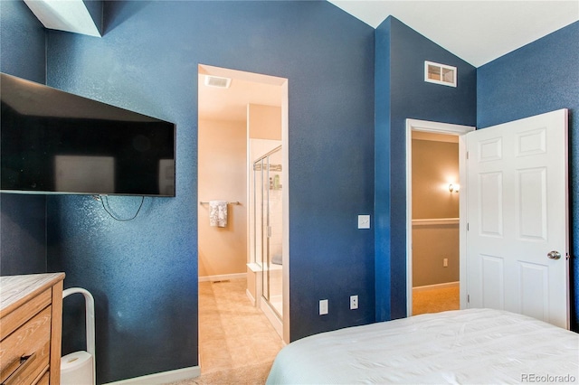 carpeted bedroom with ensuite bath and lofted ceiling