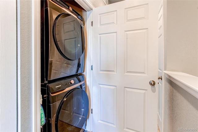 laundry area with stacked washing maching and dryer