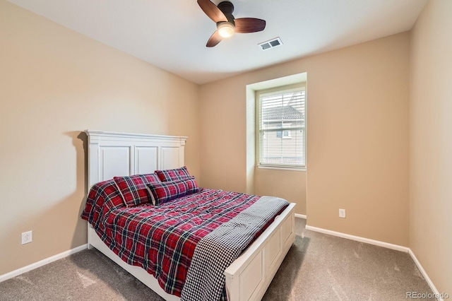 carpeted bedroom featuring baseboards and a ceiling fan