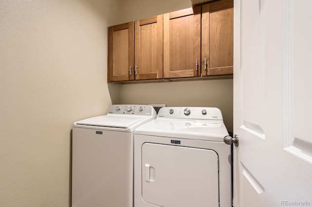 laundry area with cabinet space and separate washer and dryer