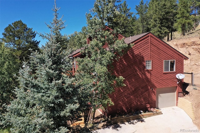 view of side of home featuring a garage