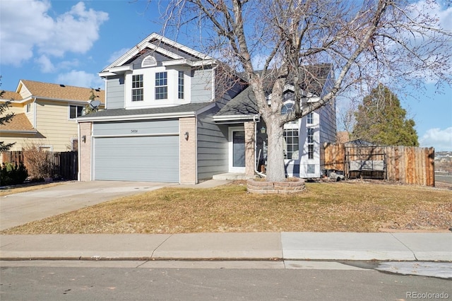 view of property with a garage and a front yard