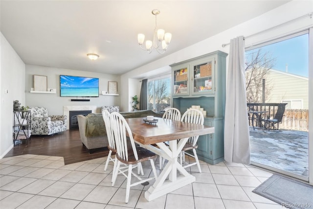 dining space with an inviting chandelier and light tile patterned floors