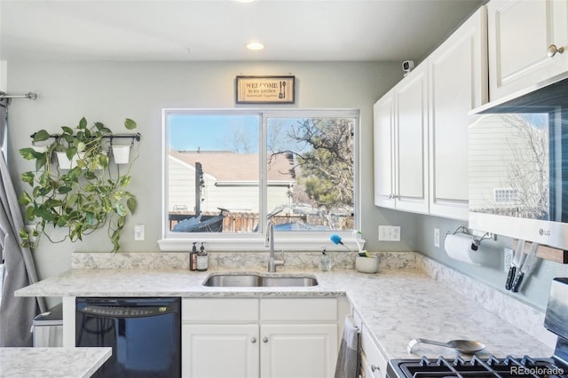 kitchen featuring white cabinets, dishwasher, sink, and stove