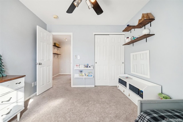 bedroom with ceiling fan, a closet, and light colored carpet