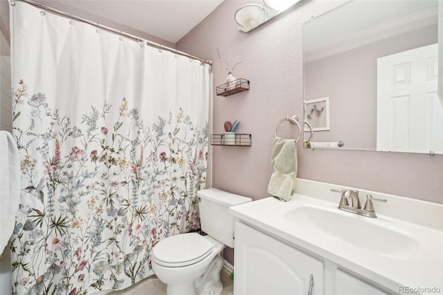 bathroom featuring toilet and vanity