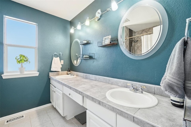 bathroom featuring tile patterned flooring, a shower with curtain, and vanity