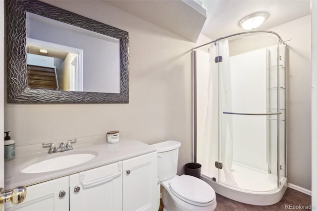 bathroom featuring toilet, vanity, and a shower with shower curtain