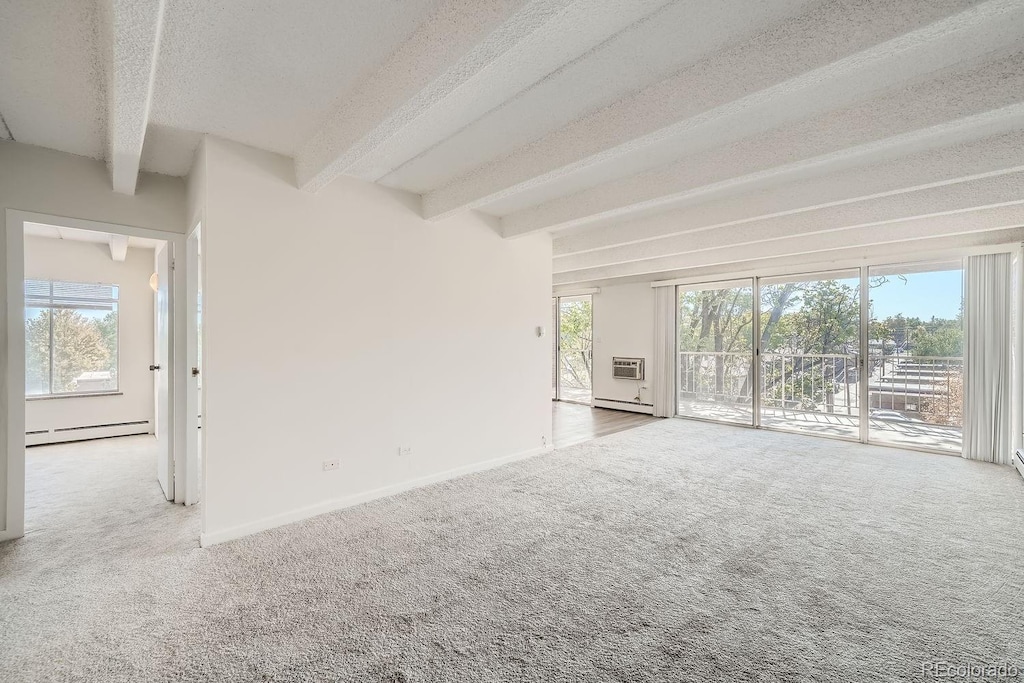 unfurnished living room featuring light carpet, a textured ceiling, a baseboard radiator, and beam ceiling