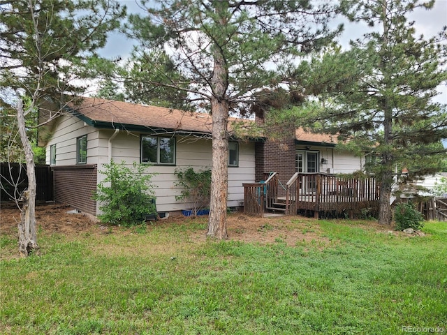 5274 W Rowland Pl, Littleton, CO 80128 - rear view of property featuring a wooden deck and a chimney