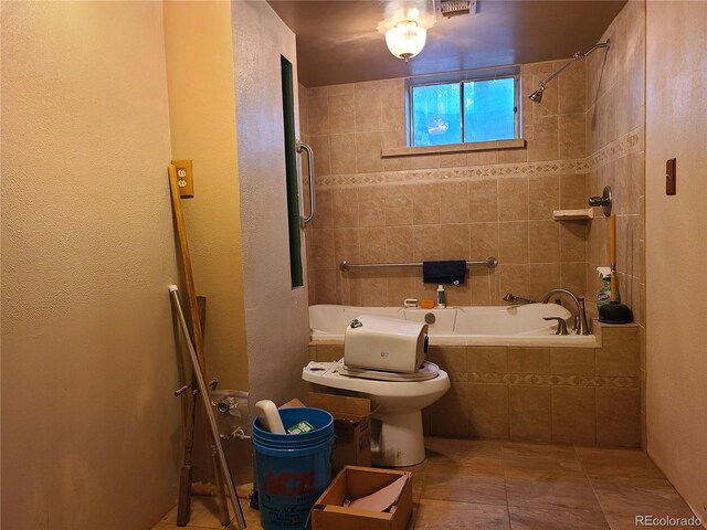 5274 W Rowland Pl, Littleton, CO 80128 - bathroom with tiled shower / bath combo, tile patterned floors, and toilet