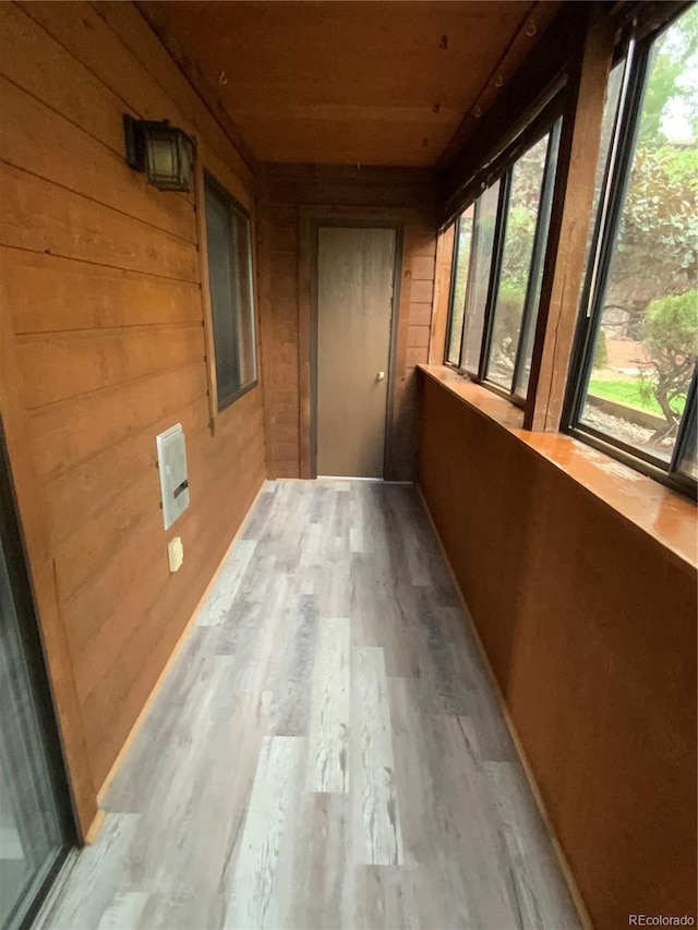 unfurnished sunroom featuring wood ceiling and a healthy amount of sunlight