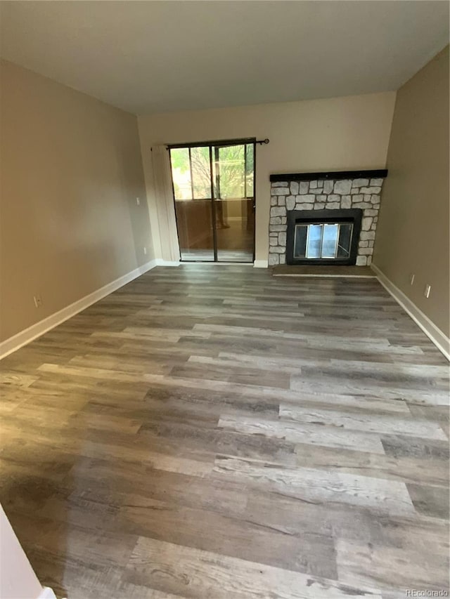 unfurnished living room featuring a fireplace and hardwood / wood-style flooring