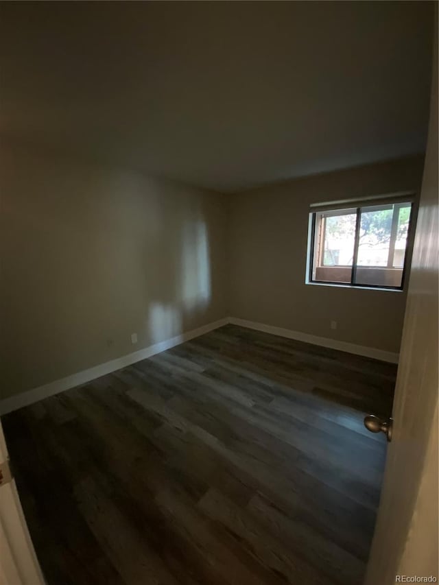 spare room with hardwood / wood-style floors