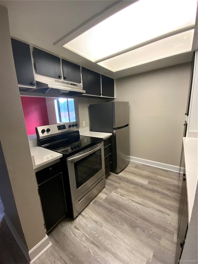 kitchen featuring refrigerator, light hardwood / wood-style floors, and stainless steel range with electric cooktop