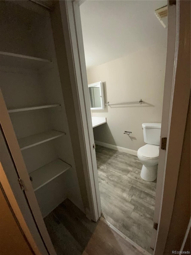 bathroom with hardwood / wood-style floors and toilet