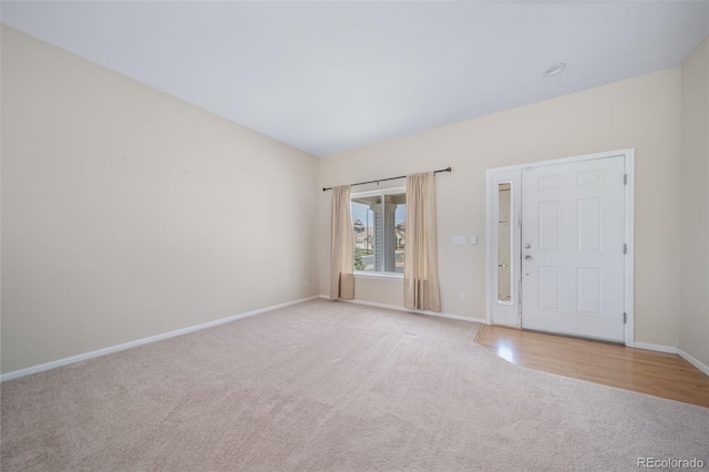 unfurnished room with carpet floors and baseboards
