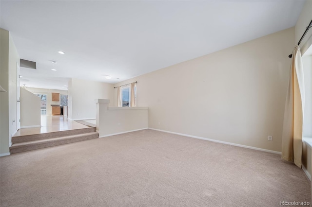 unfurnished living room with carpet, baseboards, and recessed lighting