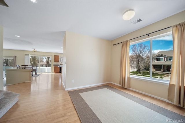 spare room featuring light wood-style flooring, baseboards, and recessed lighting