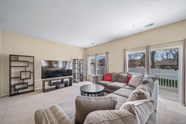 living area featuring light colored carpet and baseboards