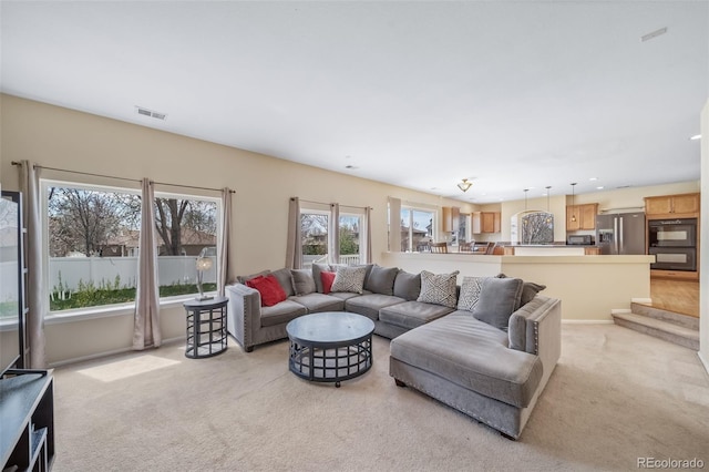 living room featuring light colored carpet and recessed lighting