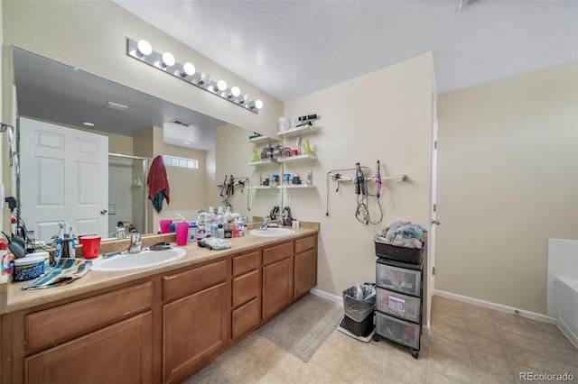 bathroom with a stall shower, double vanity, a bathtub, baseboards, and tile patterned flooring