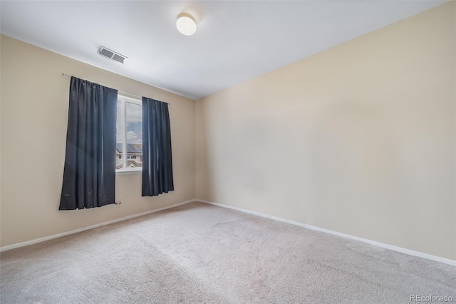 carpeted spare room featuring baseboards