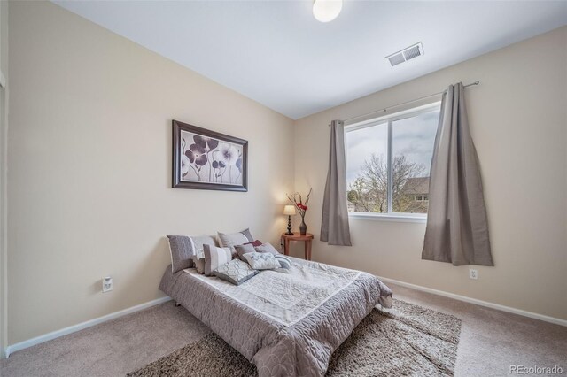 bedroom with carpet and baseboards
