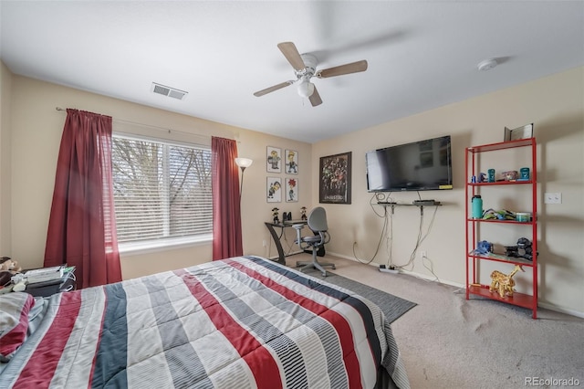 carpeted bedroom with a ceiling fan and baseboards
