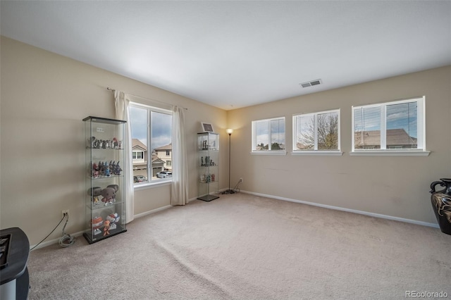 carpeted spare room featuring baseboards