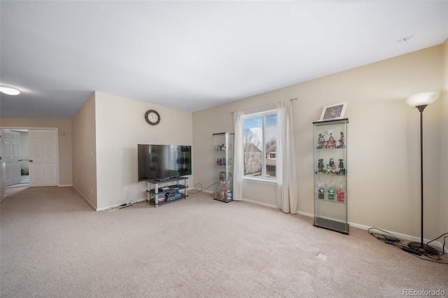 unfurnished living room with carpet floors and baseboards