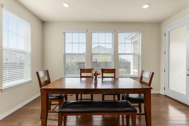 dining space featuring recessed lighting, baseboards, and light wood finished floors
