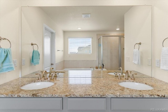 full bathroom featuring double vanity, visible vents, a sink, and a stall shower