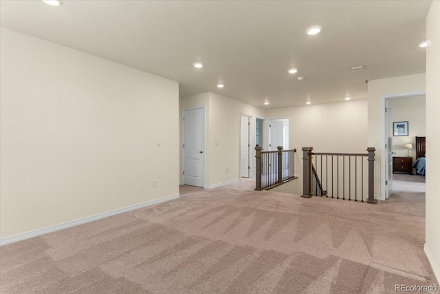 carpeted empty room with recessed lighting and baseboards