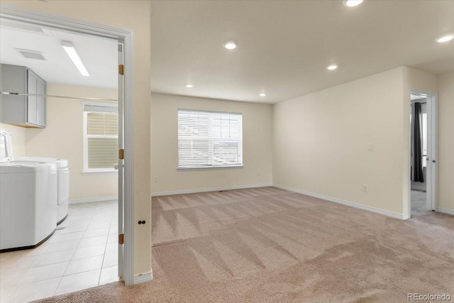 basement with recessed lighting, baseboards, light colored carpet, and washer and clothes dryer