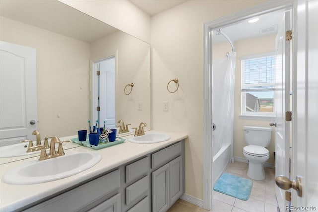 bathroom with double vanity, toilet, tile patterned floors, and a sink
